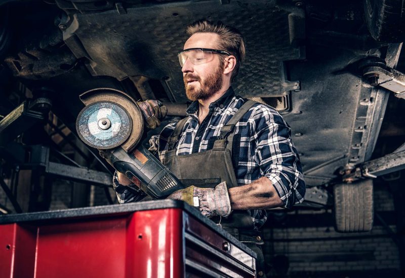 mechanic-in-protective-googles-holds-angle-grinder-small.jpg